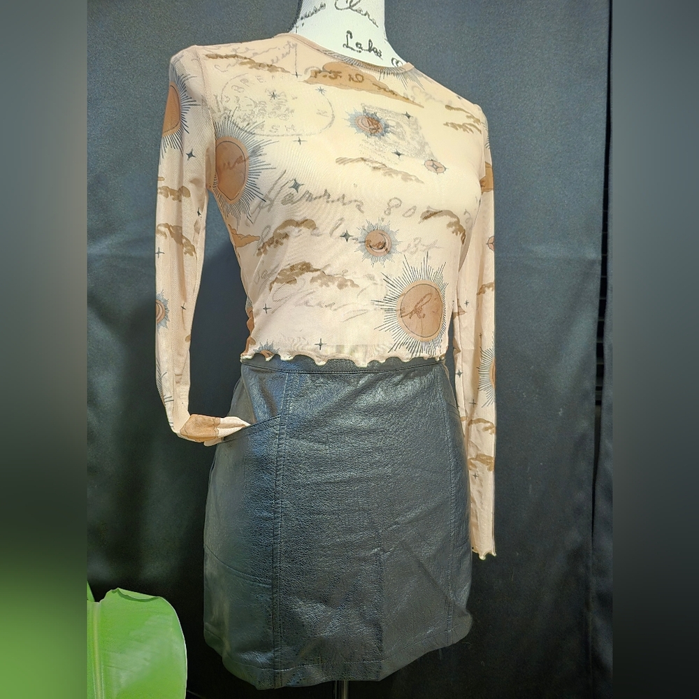 Sheer nudes color, crew neck crop top with ruffled edges on sleeves and torso.